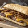 Skirt steak sandwich with grilled onions and melted cheese