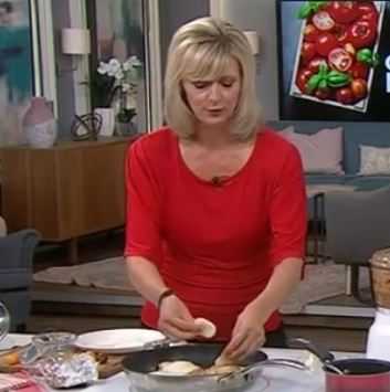 Smiling female chef – your kitchen guide at MrsRecipes.com.